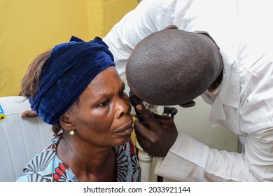 Abuja  Nigeria - August 09, 2021: African Medical Doctor Diagnosing For Eye Treatment In Rural Clinic