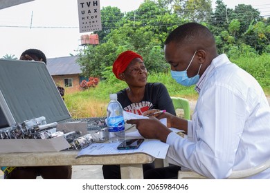 Abuja  Nigeria - August 09, 2021: African Medical Doctor Diagnosing For Eye Treatment In Rural Clinic