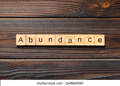 Abundance word written on wood block. Abundance text on wooden table for your desing, Top view concept. - Shutterstock ID 1648069087