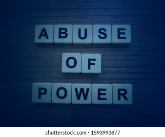 Abuse Of Power, Word Cube On Wood Background.