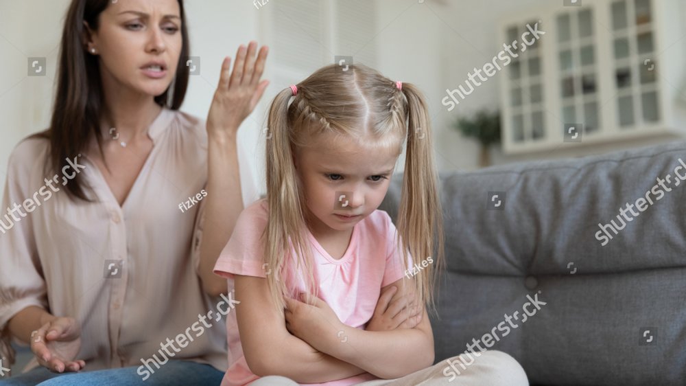 Abused stressed little preschool kid girl sitting on couch back to ...