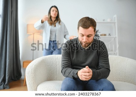 Abusive wife arguing husband, jealous distrustful dominant woman shouting at sad man.