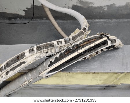 AC pipe wrapper gnawed by rats. Causing the AC pipe to quickly become damaged due to heat and rain. Photo taken from other view.