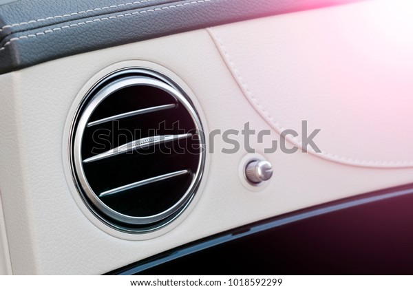 AC\
Ventilation Deck Luxury Car Interior. Modern car interior details\
white leather and natural wood. Soft\
lighting