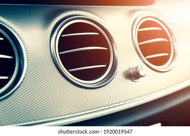 AC Ventilation Deck In Luxury Modern Car Interior. Modern Car Black Leather Interior. Natural Wood Panel. Perforated Black Leather. Car Interior. Car Inside With Sun Rays