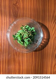 Acacia Concinna Leaves In Glass Bowl At Table