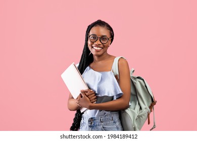 Academic Education. Young Black Woman With Backpack And Notebooks Smiling At Camera On Pink Studio Background. Young Female University Student With Afro Bunches Ready To Start School