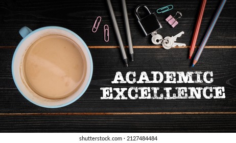 ACADEMIC EXCELLENCE. Coffee mug and colored pencils on a dark wooden background.