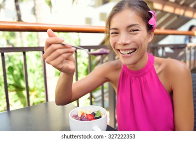 Acai Bowl - Woman Eating Healthy Food Smiling Happy. Girl Enjoy Acai Bowls Made From Acai Berries And Fruits Outdoors For Breakfast. Girl On Hawaii Eating Local Hawaiian Dish.