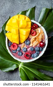 Acai Breakfast Superfoods Smoothie Bowl With Mango, Blueberry, Cherry, Coconut Flakes. Overhead, Top View, Flat Lay. 