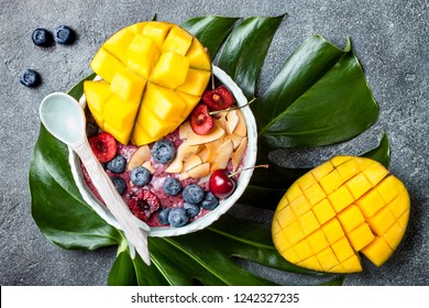 Acai Breakfast Superfoods Smoothie Bowl With Mango, Blueberry, Cherry, Coconut Flakes. Overhead, Top View, Flat Lay. 