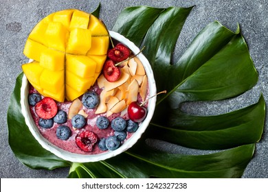 Acai Breakfast Superfoods Smoothie Bowl With Mango, Blueberry, Cherry, Coconut Flakes. Overhead, Top View, Flat Lay. 