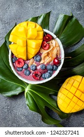 Acai Breakfast Superfoods Smoothie Bowl With Mango, Blueberry, Cherry, Coconut Flakes. Overhead, Top View, Flat Lay. 