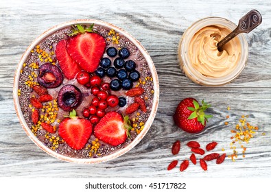 Acai Breakfast Superfoods Smoothies Bowl With Chia Seeds, Bee Pollen, Goji Berry Toppings And Peanut Butter. Overhead, Top View.