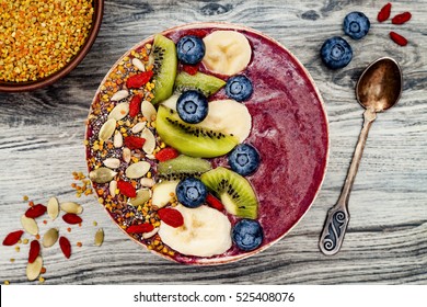 Acai Breakfast Superfoods Smoothies Bowl With Chia Seeds, Bee Pollen, Goji Berry Toppings And Fruits. Overhead, Top View, Flat Lay.