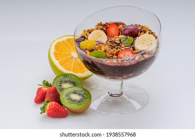 Acai With Granola And Fruits Like Strawberry, Grape, Banana, Papaya, Orange, Kiwi In A Glass Bowl On A White Background. Healthy Food.