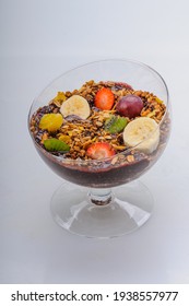 Acai With Granola And Fruits Like Strawberry, Grape, Banana, Papaya, Orange, Kiwi In A Glass Bowl On A White Background. Healthy Food.