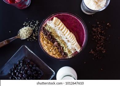 Acai Smoothie Bowl Superfood with coconut, blueberries, cacao, framboise and  hemp seeds