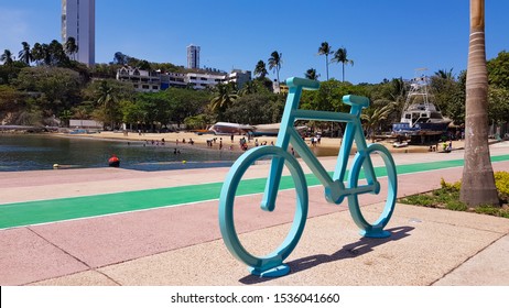 Acapulco, Mexico - April 9, 2019: bike shaped bike rack on the streets of Acapulco with a beautiful beach as background.