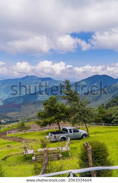 Acatenango, Guatemala - September 28, 2021 -\
vertical view of a Nissan pick up truck in the highlands of\
Guatemala with\
mountains