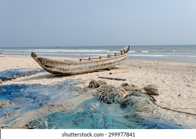 ACCARA, GHANA - JANUARY 18, 2014: Fishing Poor Boat And Nets On Sea Sand Coast In Rural Fishing Village.  In 1957, Ghana Became The First African Nation To Declare Independence From Colonization.