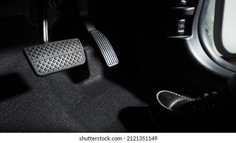 Accelerate and Brake. Foot pressing foot pedal of a car to drive ahead. Accelerator and brake pedal in a car. Driver driving the car by pushing accelerator pedals of the car. inside vehicle automobile