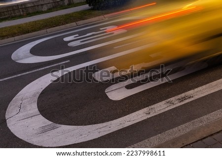 Acceleration of vehicle on speed limit sign. Image in movement, burst of light, wake of car.