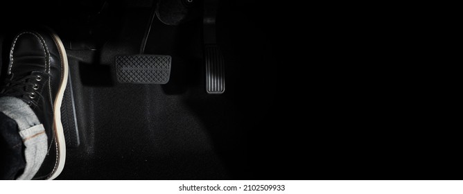 Accelerator and breaking pedal in a car. Close up the foot pressing foot pedal of a car to drive ahead. Driver driving the car by pushing accelerator pedals of the car. Foot pedals inside vehicle.