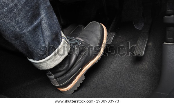 Accelerator and breaking pedal in a car. Close up the
foot pressing foot pedal of a car to drive ahead. Driver driving
the car by pushing accelerator pedals of the car. inside vehicle.

