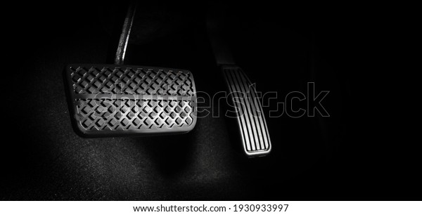 Accelerator and breaking pedal in a car. Close up the\
foot pressing foot pedal of a car to drive ahead. Driver driving\
the car by pushing accelerator pedals of the car. inside vehicle.\
\
