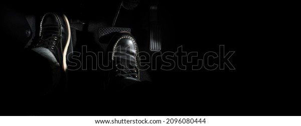 Accelerator and breaking pedal in a car. Close\
up the foot pressing foot pedal of a car to drive ahead. Driver\
driving the car by pushing accelerator pedals of the car. Foot\
pedals inside\
vehicle.