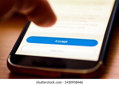 Accept Button On Smartphone Screen Closeup With Human Finger Pointing To It