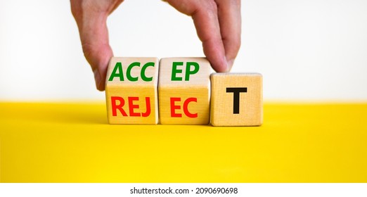 Accept or reject symbol. Businessman turns wooden cubes and changes the word reject to accept. Beautiful yellow table, white background, copy space. Business and accept or reject concept.