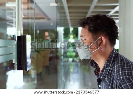 Access control facial recognition system. A man faces scanning the modern technology security . Bio metric admittance control device for security system.                              