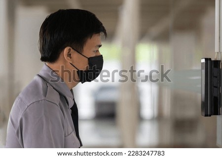 Access control facial recognition system. A man faces scanning the modern technology security . Bio metric admittance control device for security system.                              