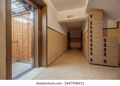 Access door to an elevator and mailboxes to collect postal shipments
