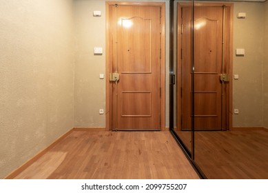 Access Door To A Residential Home With Mirrored Sliding Door Closet To One Side