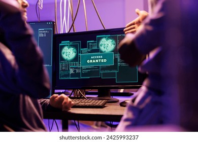 Access granted message on hackers computer screen after breaking into online server. Two criminals happy successful network system password hacking notification on monitor
