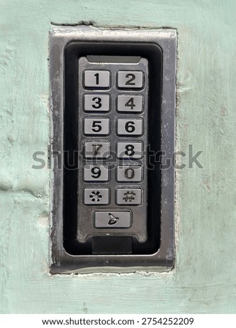 An access keypad embedded in the wall to secure entry for residents of an apartment building.