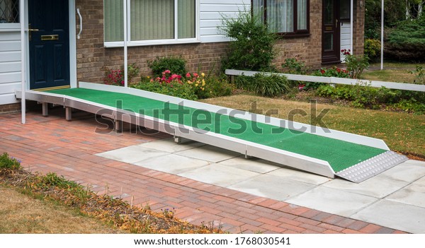 A access ramp installed at the door\
to a building so that a disabled person can access\
it
