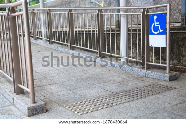 Access Ramp Sign for wheelchair ramp, an\
inclined plane installed in addition to or instead of stairs, for\
wheelchair users, people pushing strollers, carts, or wheeled\
objects to access\
buildings.
