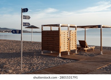 Accessible beach facilities in Greece with changing room, pergola, pathways and directional signs for people with disabilities. Inclusive seaside tourism infrastructure.