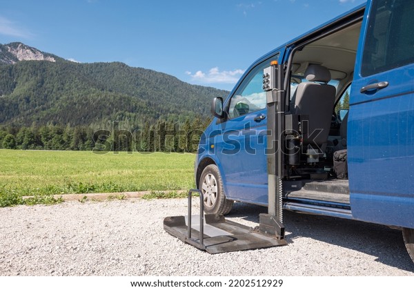 Accessible car with wheelchair lift ramp for\
person with\
disability.