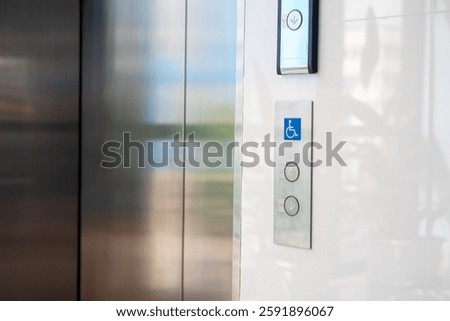 An accessible elevator control panel featuring a disability symbol, tactile buttons, and a modern design, enhancing user experience and independence.