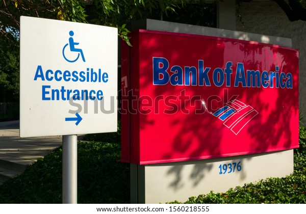 Accessible entrance sign with right arrow directs\
Bank Of America customers to ADA compliant entrance - Cupertino,\
California, USA -\
2019