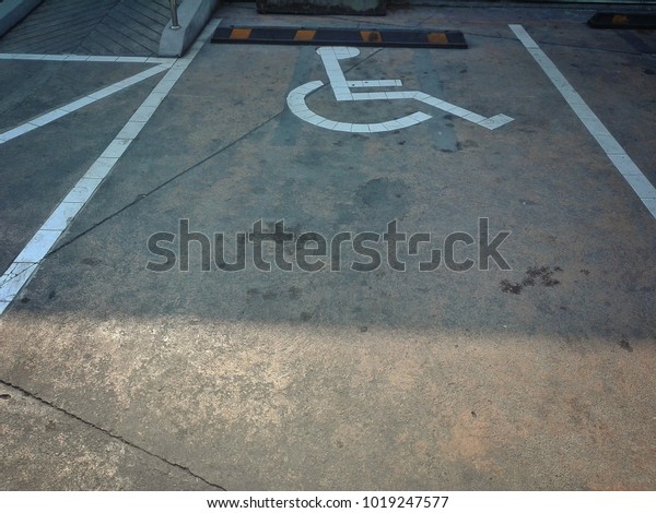 Accessible parking There are drawings\
white color of the disabled sitting on the\
wheelchair.
