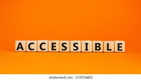 Accessible symbol. The word accessible on wooden cubes. Beautiful orange table, orange background. Business and accessible concept. Copy space.