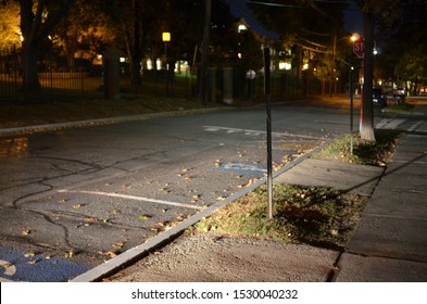 An Accessible/handicap Parking Spot At Night, With Headlights Shining On It