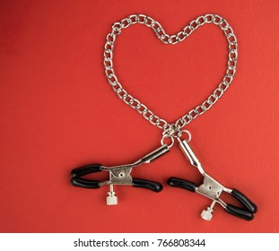 Accessories for BDSM on a red background.
