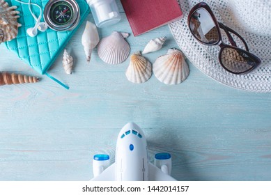 Accessories For A Bright Summer Sunny Holiday In The Resort. Items For Travel To The Sea Laid Out On A Wooden Table. Top View